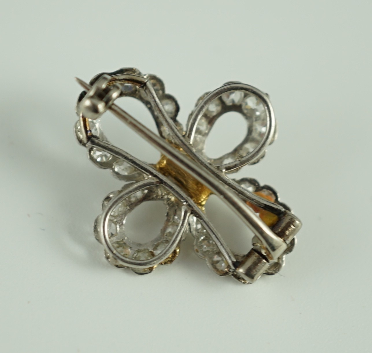 A 1940's white gold? and millegrain set diamond cluster set open work quatrefoil shaped brooch